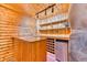 Home bar with wood paneling, custom shelving, and a beverage cooler at 879 S Cole Dr, Lakewood, CO 80228