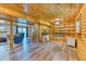 Basement area with a wood paneled ceiling, wood look floors, and built in bookshelves at 879 S Cole Dr, Lakewood, CO 80228