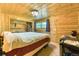 Bedroom with wood paneling, closet, and view of the outdoor scenery at 879 S Cole Dr, Lakewood, CO 80228