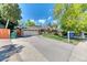 Ranch style home with a two car garage, basketball hoop, and green lawn at 879 S Cole Dr, Lakewood, CO 80228