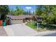 Attractive single-Gathering home with a brick facade, two-car garage, mature trees, and a well-manicured lawn at 879 S Cole Dr, Lakewood, CO 80228