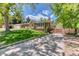Charming brick home with a well-maintained lawn and inviting front porch at 879 S Cole Dr, Lakewood, CO 80228