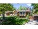 A beautiful brick home with a well-maintained lawn, mature trees, and inviting curb appeal at 879 S Cole Dr, Lakewood, CO 80228
