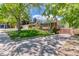 Charming home featuring a well-manicured front lawn, ample parking, and a welcoming entrance at 879 S Cole Dr, Lakewood, CO 80228