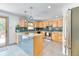 Modern kitchen with updated appliances, light wood cabinets, and a stylish tile backsplash at 879 S Cole Dr, Lakewood, CO 80228