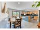 Open kitchen with a blue tile island, stainless steel appliances, and a dining area at 879 S Cole Dr, Lakewood, CO 80228
