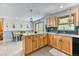 Charming kitchen featuring wood cabinets, granite countertops, blue backsplash, a dining area and natural light at 879 S Cole Dr, Lakewood, CO 80228