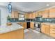 Well-equipped kitchen with stainless steel appliances, granite countertops, and custom cabinetry at 879 S Cole Dr, Lakewood, CO 80228