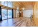 Spacious living area with wood paneling, a walkout to the deck, and natural light at 879 S Cole Dr, Lakewood, CO 80228
