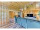 Inviting living area featuring wood paneling, a stone fireplace, and comfortable seating at 879 S Cole Dr, Lakewood, CO 80228