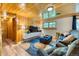 Comfortable living room with wood paneling, modern entertainment center, and stylish decor at 879 S Cole Dr, Lakewood, CO 80228