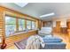 Bright living room with skylights, large windows with seating, and hardwood floors at 879 S Cole Dr, Lakewood, CO 80228