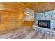 Living room showcases rustic wood paneling and a stone fireplace at 879 S Cole Dr, Lakewood, CO 80228