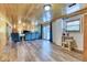 Open concept living space with wood paneling, outdoor access, and ample seating at 879 S Cole Dr, Lakewood, CO 80228