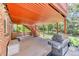 Covered outdoor patio and grill area that leads to the backyard at 879 S Cole Dr, Lakewood, CO 80228