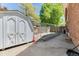 Backyard storage shed and empty garden space next to a brick house at 879 S Cole Dr, Lakewood, CO 80228