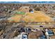 Aerial view of a town featuring a park, tennis courts, and a cityscape backdrop at 4000 Irving St, Denver, CO 80211