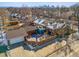 Aerial view of a house featuring a brick patio, garage, and nearby city skyline at 4000 Irving St, Denver, CO 80211