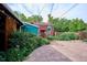 Backyard features a paver patio, lush landscaping, and cozy outdoor lighting creating a private and inviting retreat at 4000 Irving St, Denver, CO 80211
