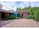 This home's backyard features a brick patio, lush landscaping, and ample space for outdoor entertaining and relaxation at 4000 Irving St, Denver, CO 80211