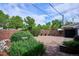 Paver patio is surrounded by lush landscaping, brick walls, and charming potted plants creating a serene outdoor space at 4000 Irving St, Denver, CO 80211