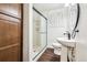 Modern bathroom features a glass-door shower, wood cabinet, and vanity sink at 4000 Irving St, Denver, CO 80211