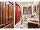 A bathroom features wood cabinets, marble countertops, and a shower with a red curtain at 4000 Irving St, Denver, CO 80211