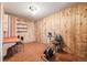 Cozy bedroom with wood paneling, an exercise bike, desk, and carpet at 4000 Irving St, Denver, CO 80211