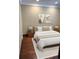 A clean bedroom features neutral decor, wood floors, and simple yet elegant furnishings at 4000 Irving St, Denver, CO 80211