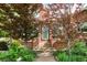 Charming brick home featuring a walkway and landscaped garden with mature trees at 4000 Irving St, Denver, CO 80211