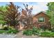 Beautiful brick home featuring a walkway, manicured lawn and mature trees at 4000 Irving St, Denver, CO 80211