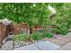 Beautiful brick home with lush greenery, landscaped garden, and stone accents adding to its curb appeal at 4000 Irving St, Denver, CO 80211