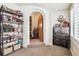 A decorated hallway features exposed brick, a variety of clocks, and a glimpse into another room at 4000 Irving St, Denver, CO 80211