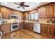 A kitchen features warm wood cabinetry, stainless steel appliances, and granite countertops at 4000 Irving St, Denver, CO 80211