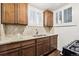 Stylish kitchen featuring granite counters, wood cabinets, and stainless appliances at 4000 Irving St, Denver, CO 80211