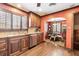 A kitchen with warm wood cabinets and stainless steel appliances leads to a breakfast nook at 4000 Irving St, Denver, CO 80211