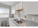 Bright kitchen featuring granite countertops, stainless steel sink and white cabinets at 3872 S Fraser St # O03, Aurora, CO 80014