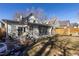 Large backyard featuring a patio seating area, well-manicured lawn and privacy fence at 858 S Emerson St, Denver, CO 80209