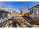 Fenced backyard with green and dormant grasses, stepping stones, and cozy seating at 858 S Emerson St, Denver, CO 80209