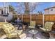 Relaxing backyard seating area with comfortable chairs, glass table and fenced yard at 858 S Emerson St, Denver, CO 80209