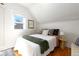 Bright bedroom featuring a large window, white walls, and wood floor at 858 S Emerson St, Denver, CO 80209