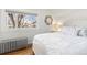 Bright bedroom features hardwood floors, large window and decoratively framed mirror at 858 S Emerson St, Denver, CO 80209