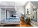 Cozy bedroom featuring a white-framed bunk bed, hardwood floors, and unique wall art at 858 S Emerson St, Denver, CO 80209