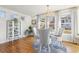 Sun-filled dining room with hardwood floors, a chandelier, large windows, and a round table with four chairs at 858 S Emerson St, Denver, CO 80209