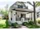 Charming home featuring a covered porch, decorative gables, and landscaped front yard at 858 S Emerson St, Denver, CO 80209