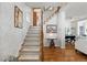 Inviting foyer with hardwood floors, elegant staircase and trim, and tastefully decorated walls at 858 S Emerson St, Denver, CO 80209