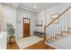 Inviting foyer with hardwood floors, a staircase, and elegant decor at 858 S Emerson St, Denver, CO 80209