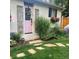 Charming home exterior with a pink front door, quaint garden, and stone pathway at 858 S Emerson St, Denver, CO 80209