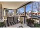 Inviting front porch with comfortable seating and a stylish black and white rug at 858 S Emerson St, Denver, CO 80209