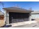 Detached garage with a black garage door, concrete driveway and updated exterior at 858 S Emerson St, Denver, CO 80209